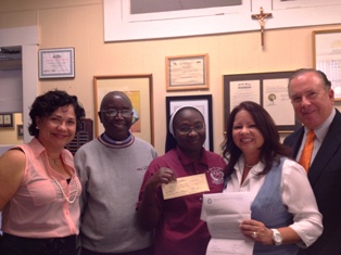 Presenting a check in support of the school's health and science lab.